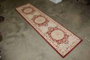 An approx. 8'4" x 2'3" floral patterned rug