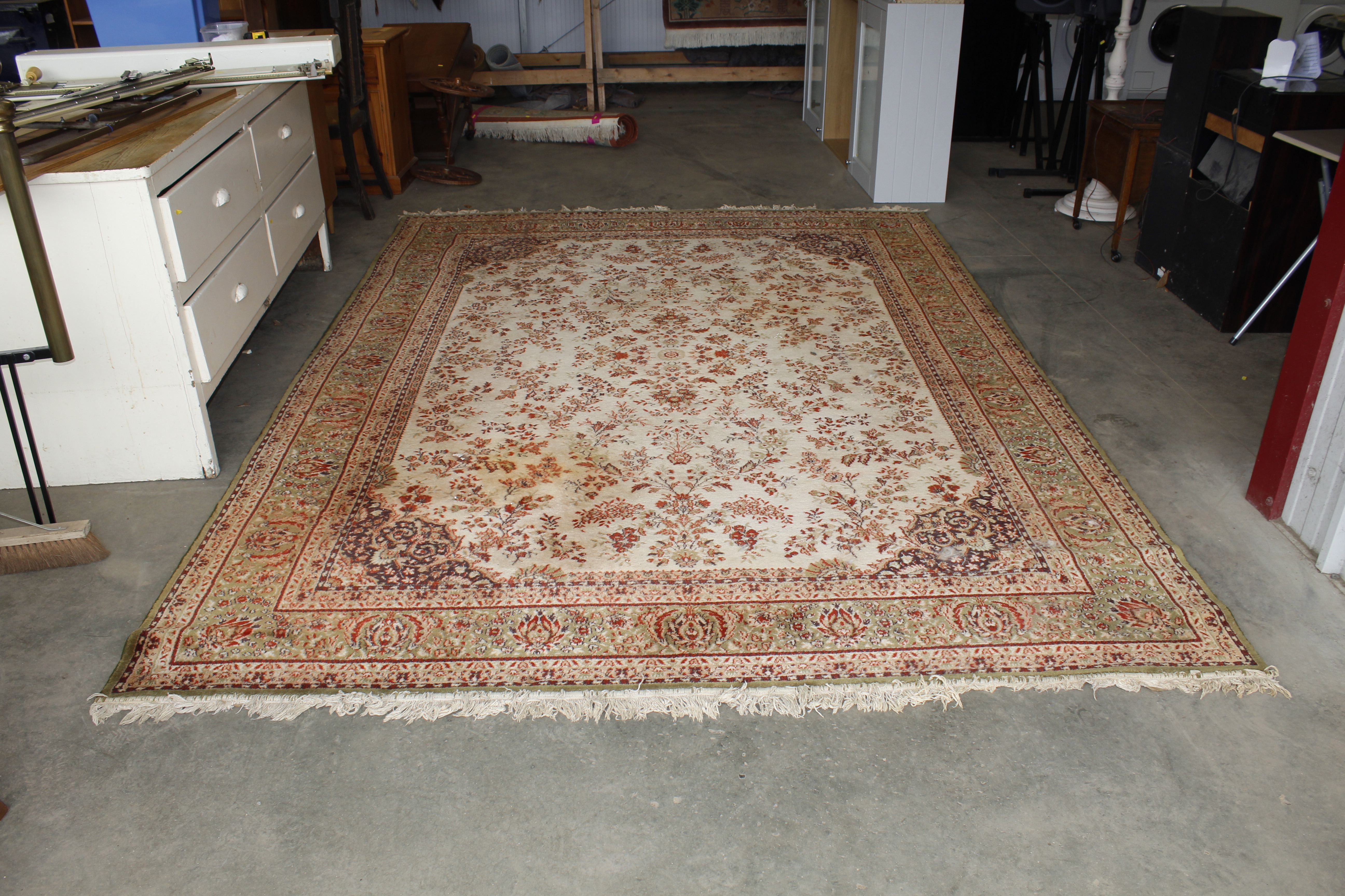 An approx. 11'7" x 8'1" green patterned rug AF