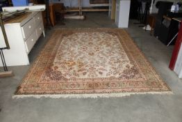 An approx. 11'7" x 8'1" green patterned rug AF