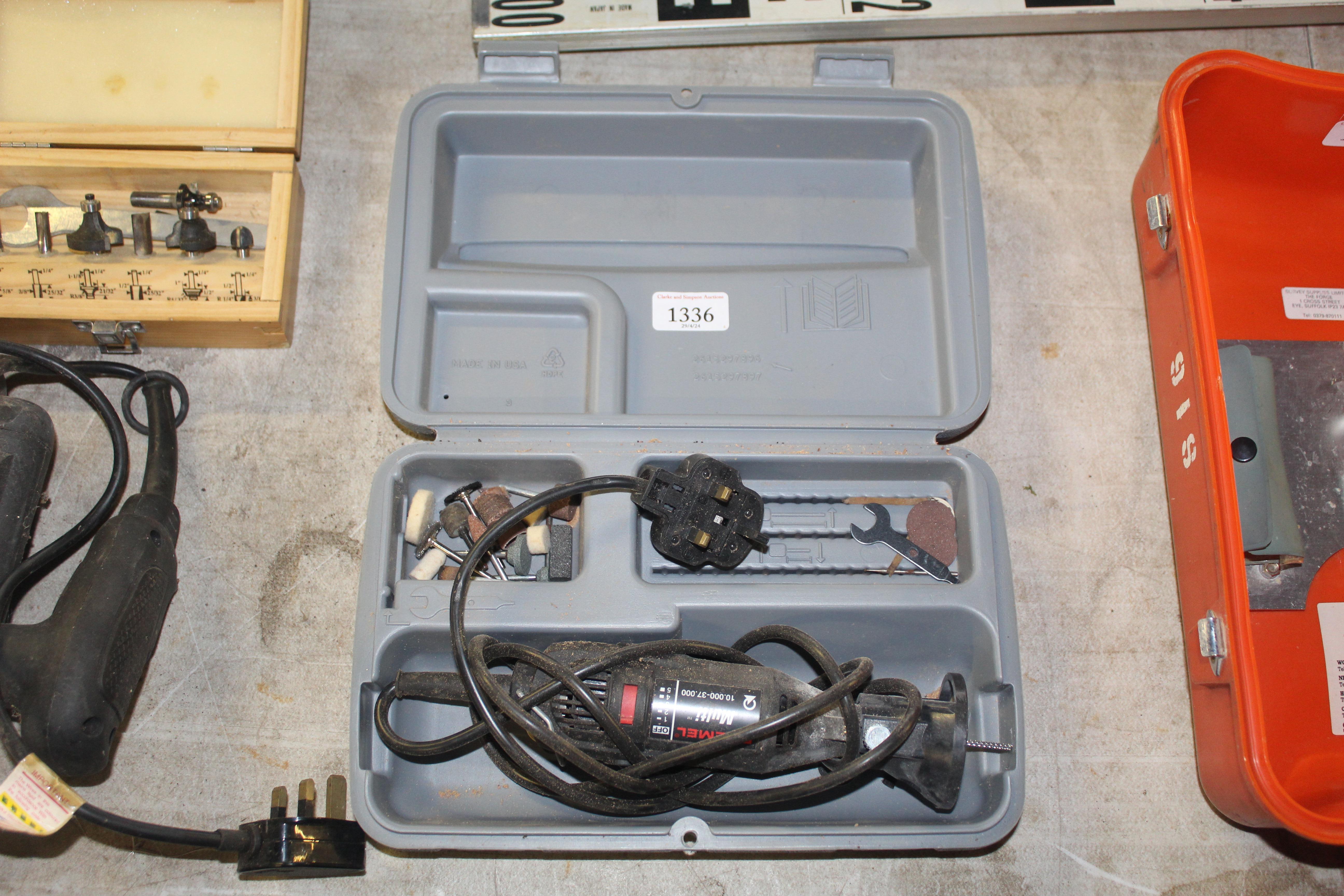 A Dremel multi tool in plastic case with various a