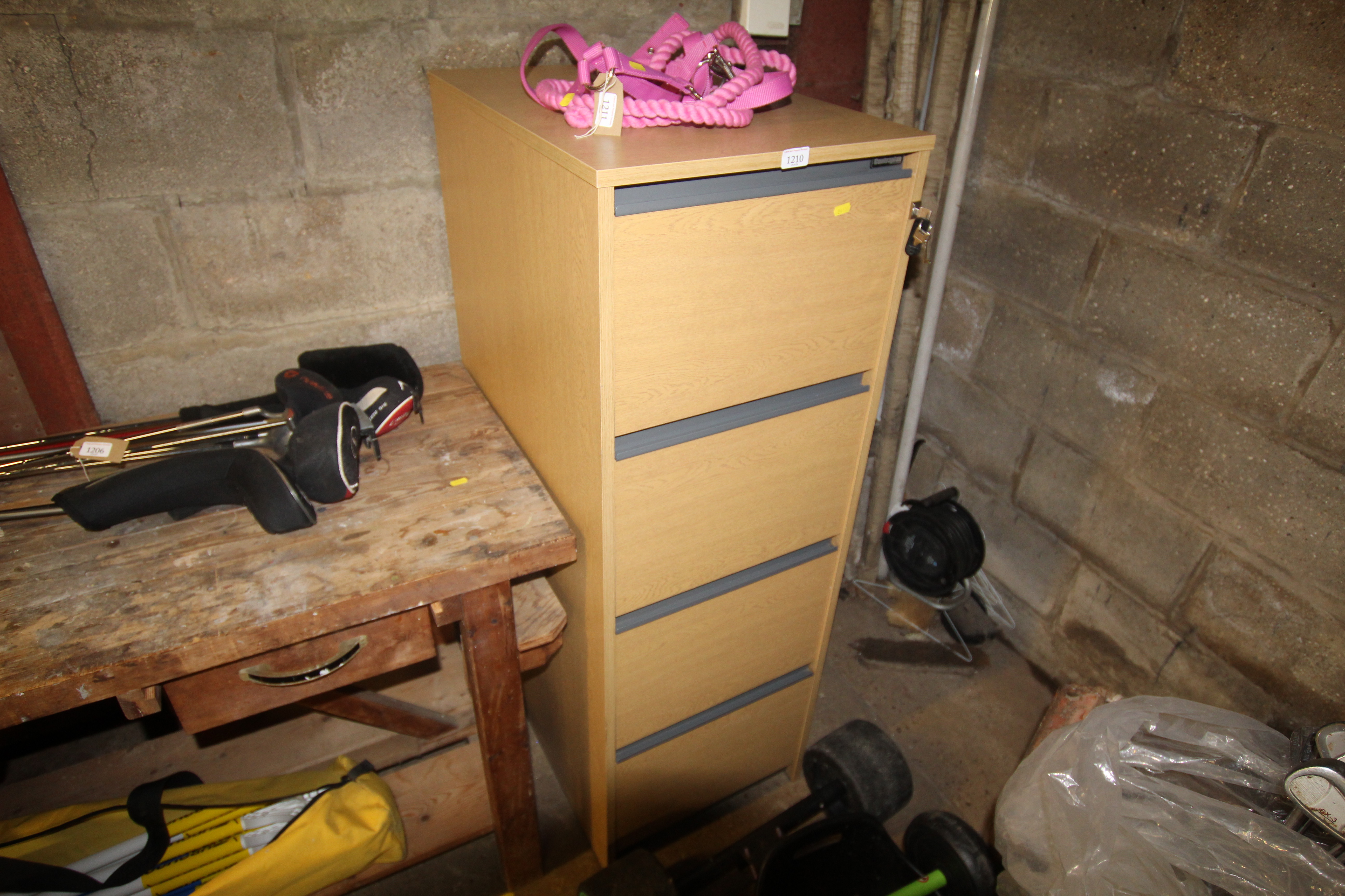 A wood effect four drawer filing cabinet with key