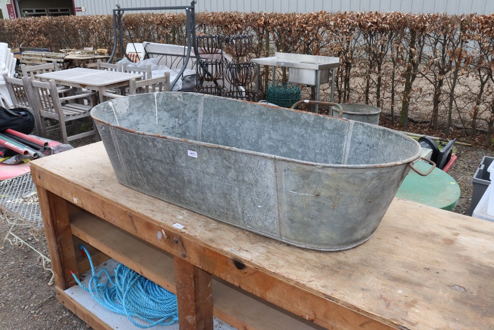 A galvanised twin handed bath