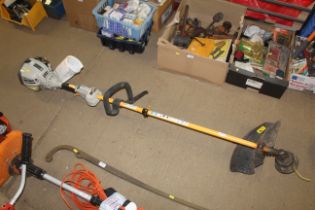 A Ryobi petrol strimmer with instruction guide