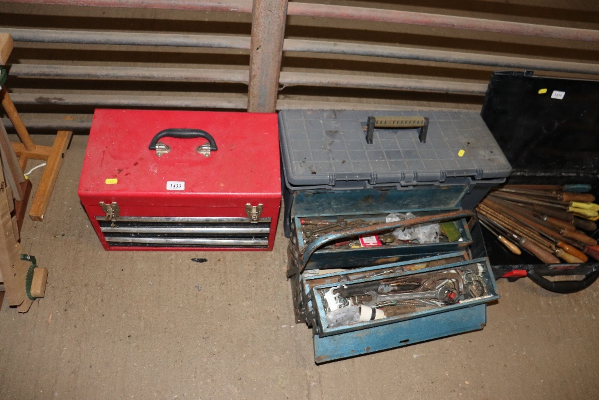 A small metal tool box comprising three drawers an