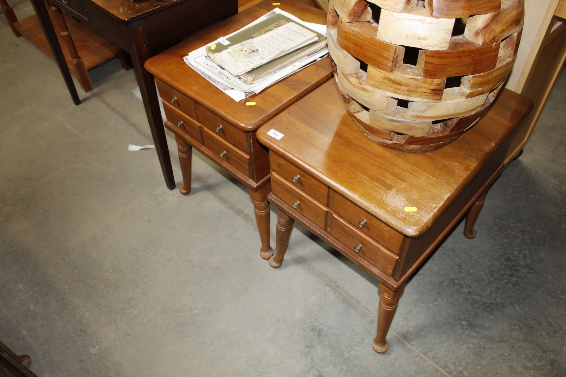 A pair of bedside tables fitted two drawers