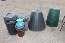 A quantity of black plastic dustbins with lids; pl