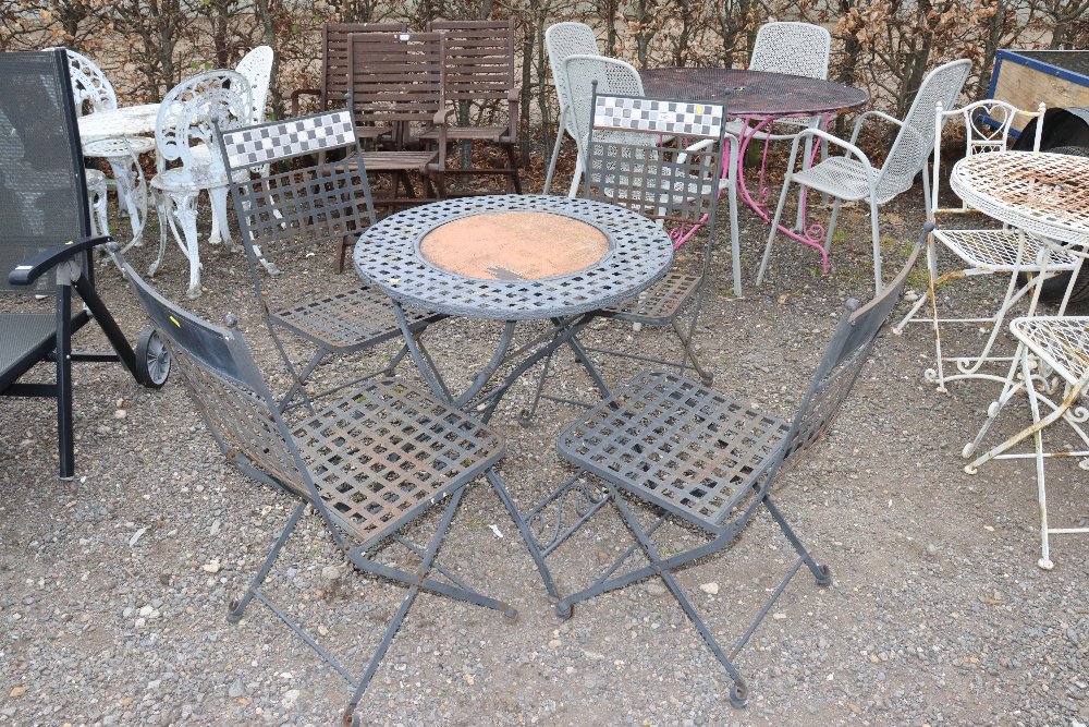 A circular lattice topped garden table and set of