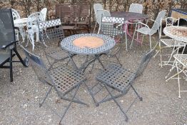 A circular lattice topped garden table and set of