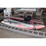 A Bic windsurfing board; four masts; five steering