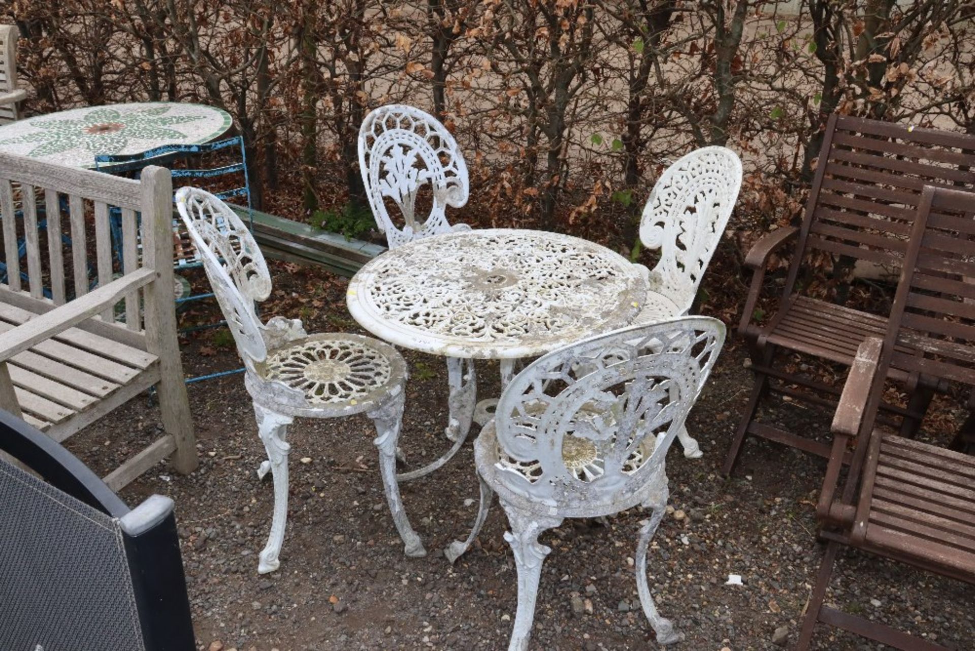 A white painted aluminium ornate table and set of