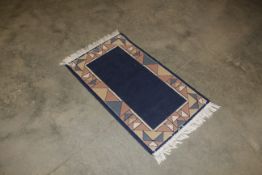 An approx. 4'2" x 2'1" modern patterned rug
