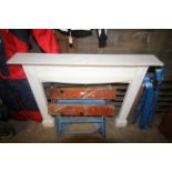 A wooden white painted fire surround