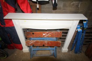 A wooden white painted fire surround