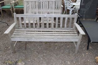 A teak three seater garden bench