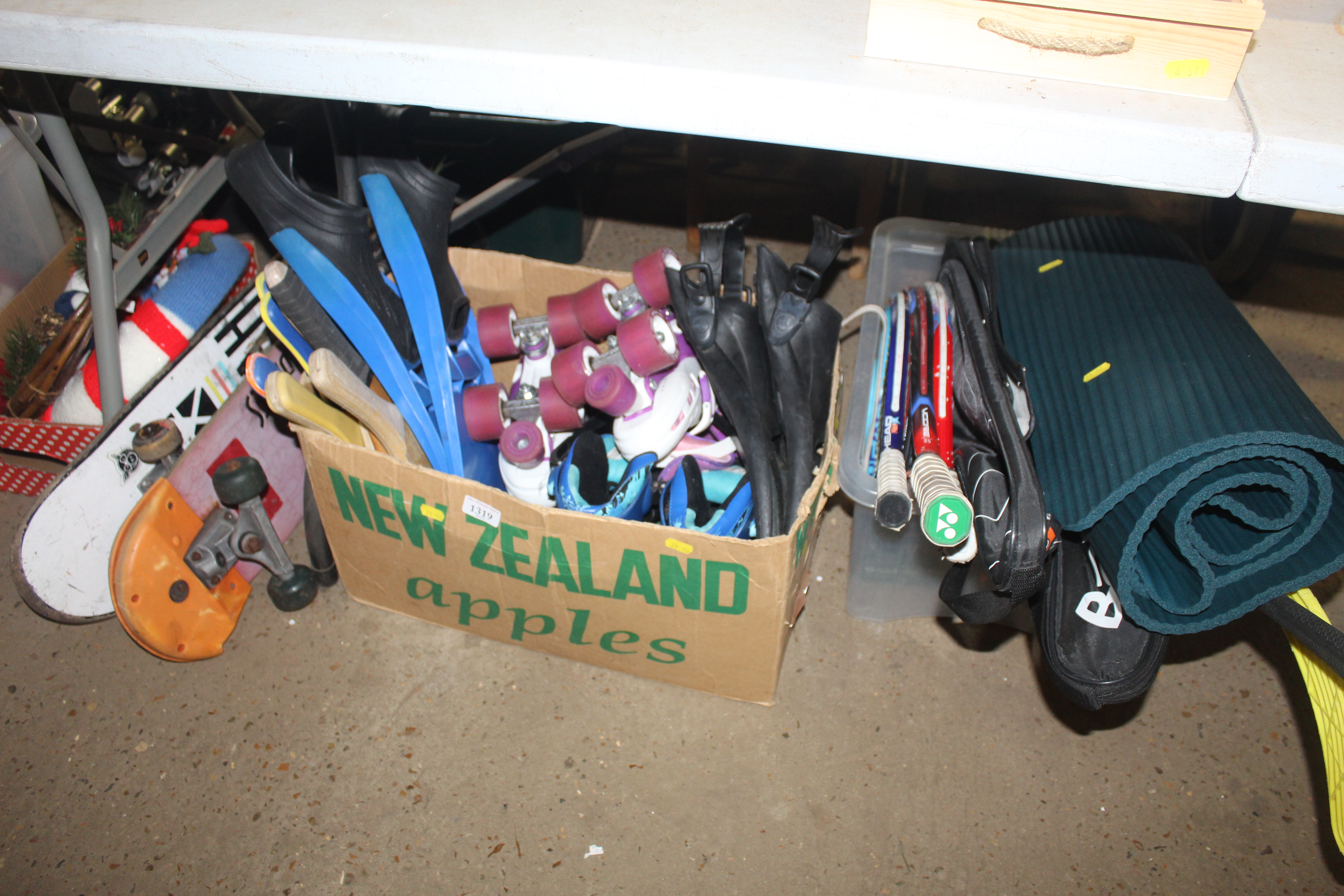 A quantity of wooden paddles, roller skating shoes, snorkelling flippers, a quantity of various