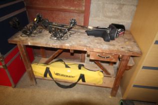 A wooden workbench fitted single drawer and shelf