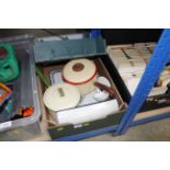 A box containing various enamel ware and a wall sh