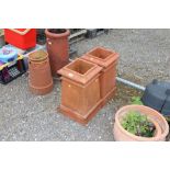 Two terracotta square chimney pots