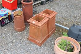 Two terracotta square chimney pots