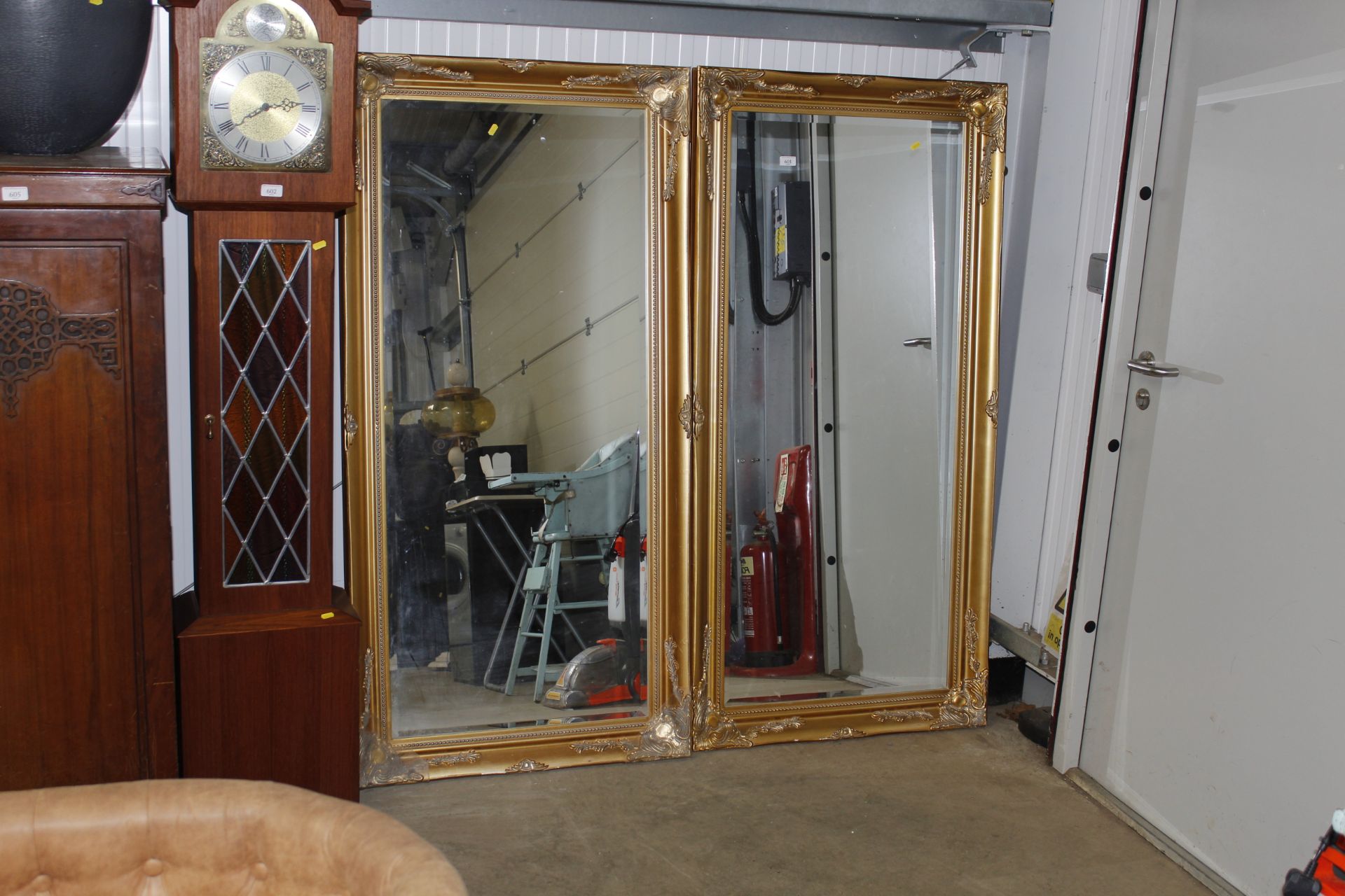 A pair of gilt framed bevelled edged wall mirror