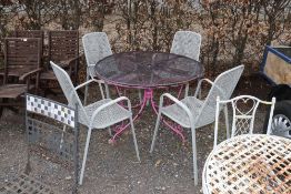 A circular metal garden table and matching set of