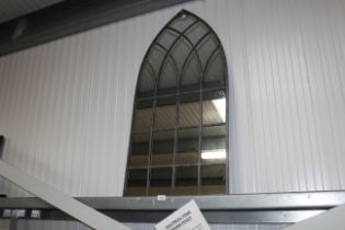 An arch framed wall mirror (150)