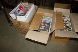 Two boxes containing Private Eye magazines