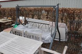A garden swing seat with overhead canopy