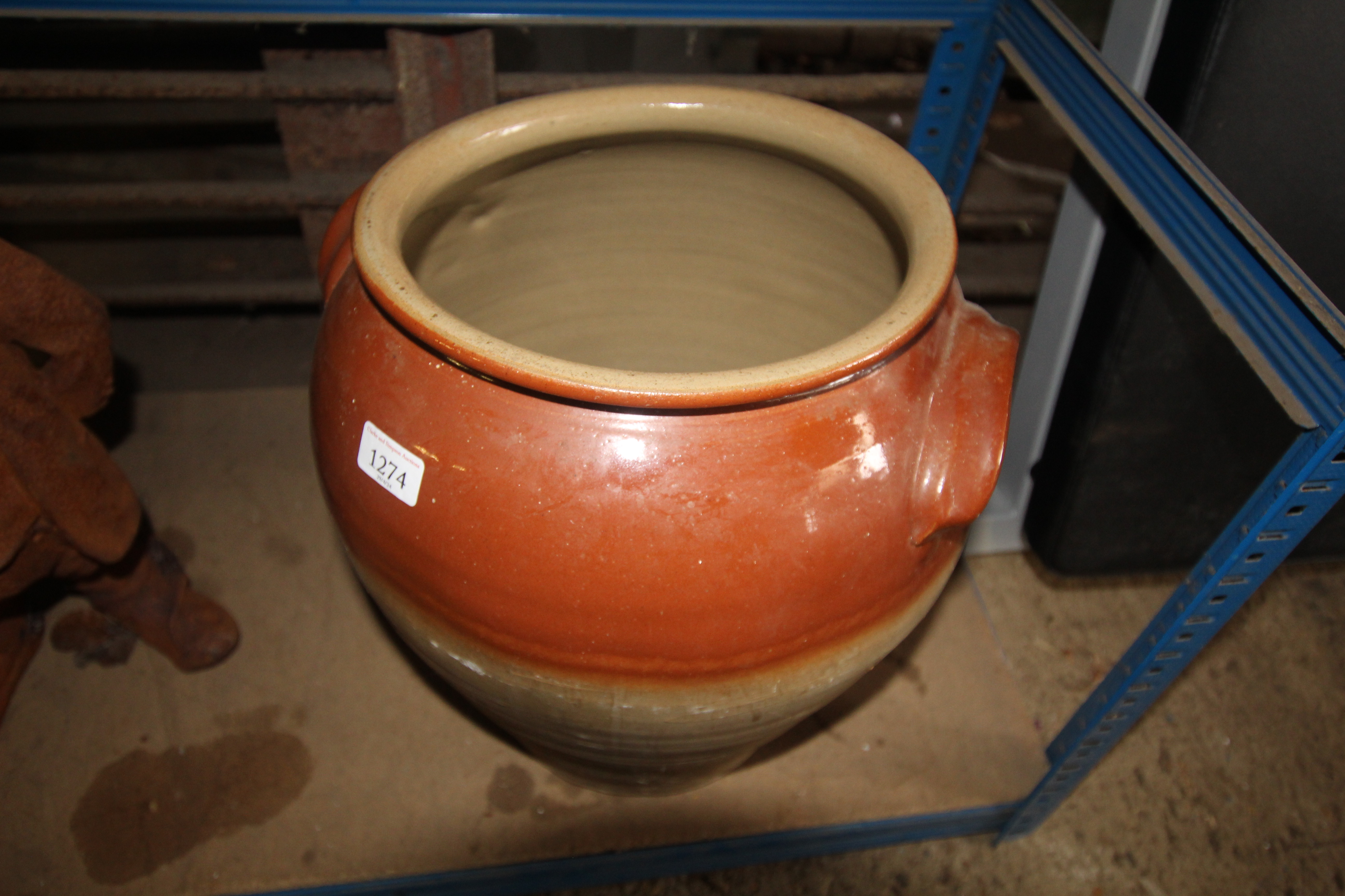 A large partly glazed twin handled stoneware jug