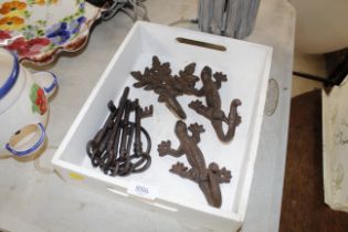 Three cast iron coat hooks and a set of replica pr