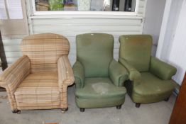 A pair of upholstered deep seated armchairs and on