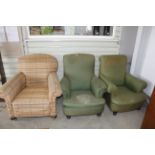 A pair of upholstered deep seated armchairs and on