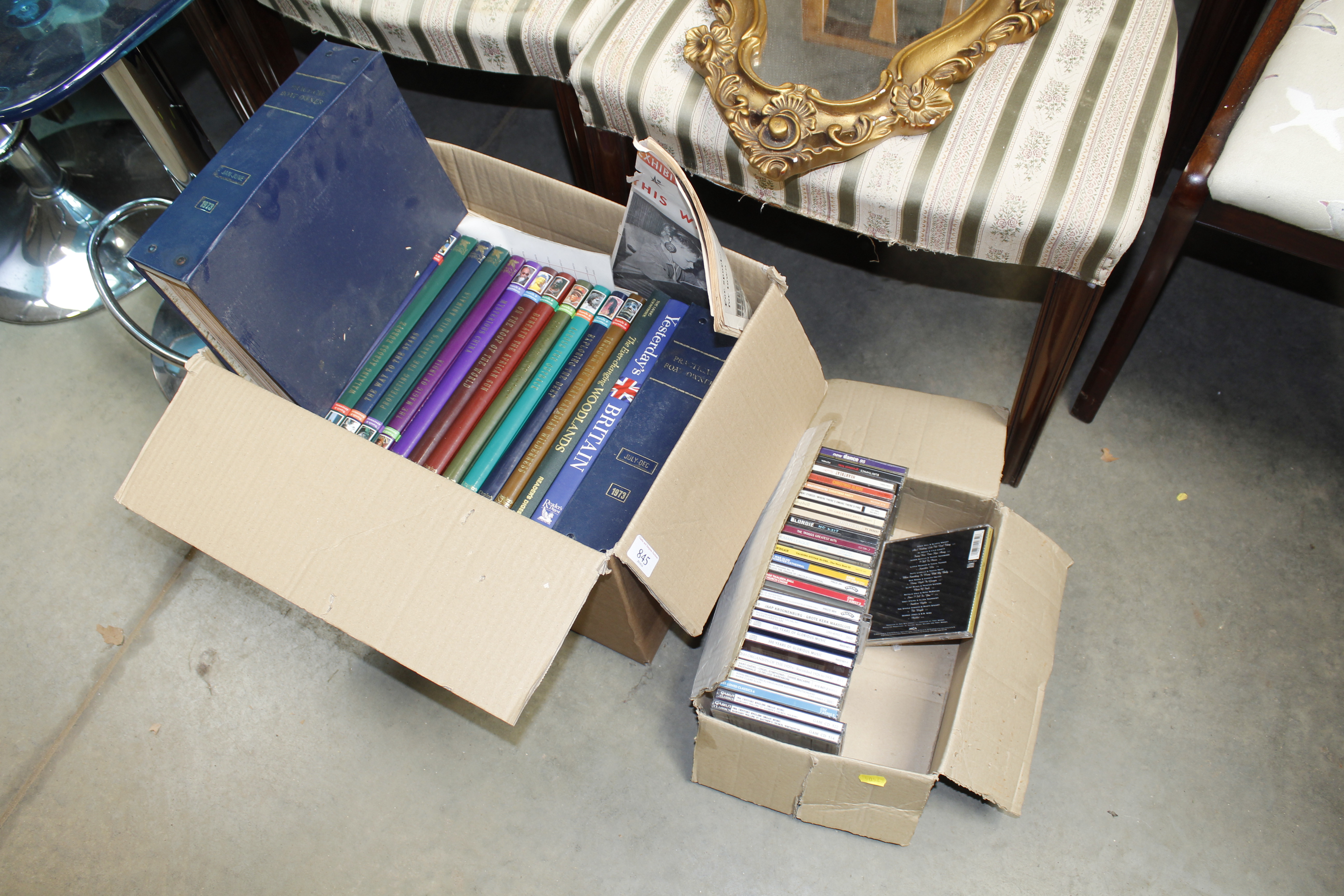 Two boxes containing books and CDs