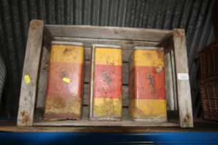 A wooden slatted crate containing three vintage ti