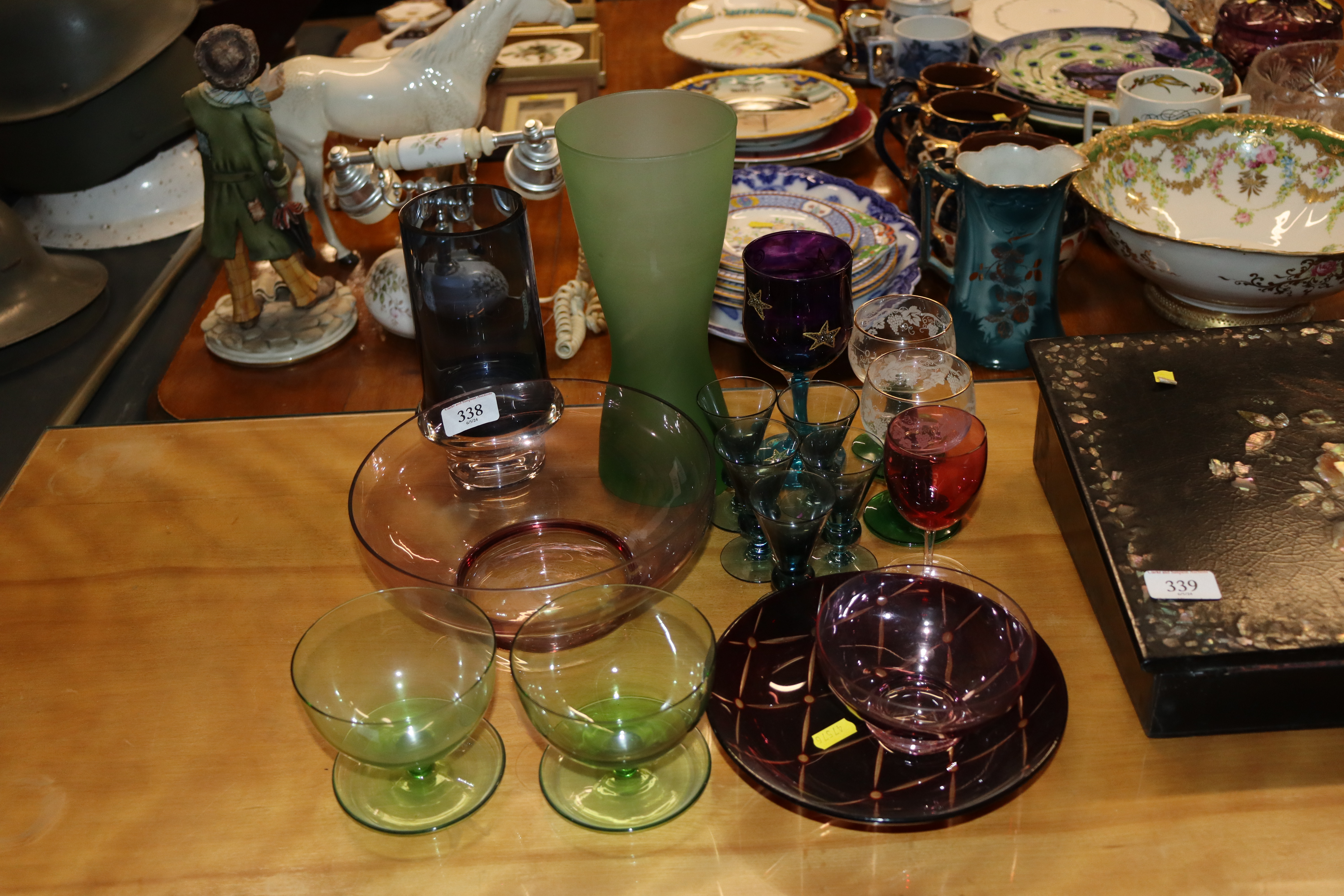 A collection of various coloured glassware