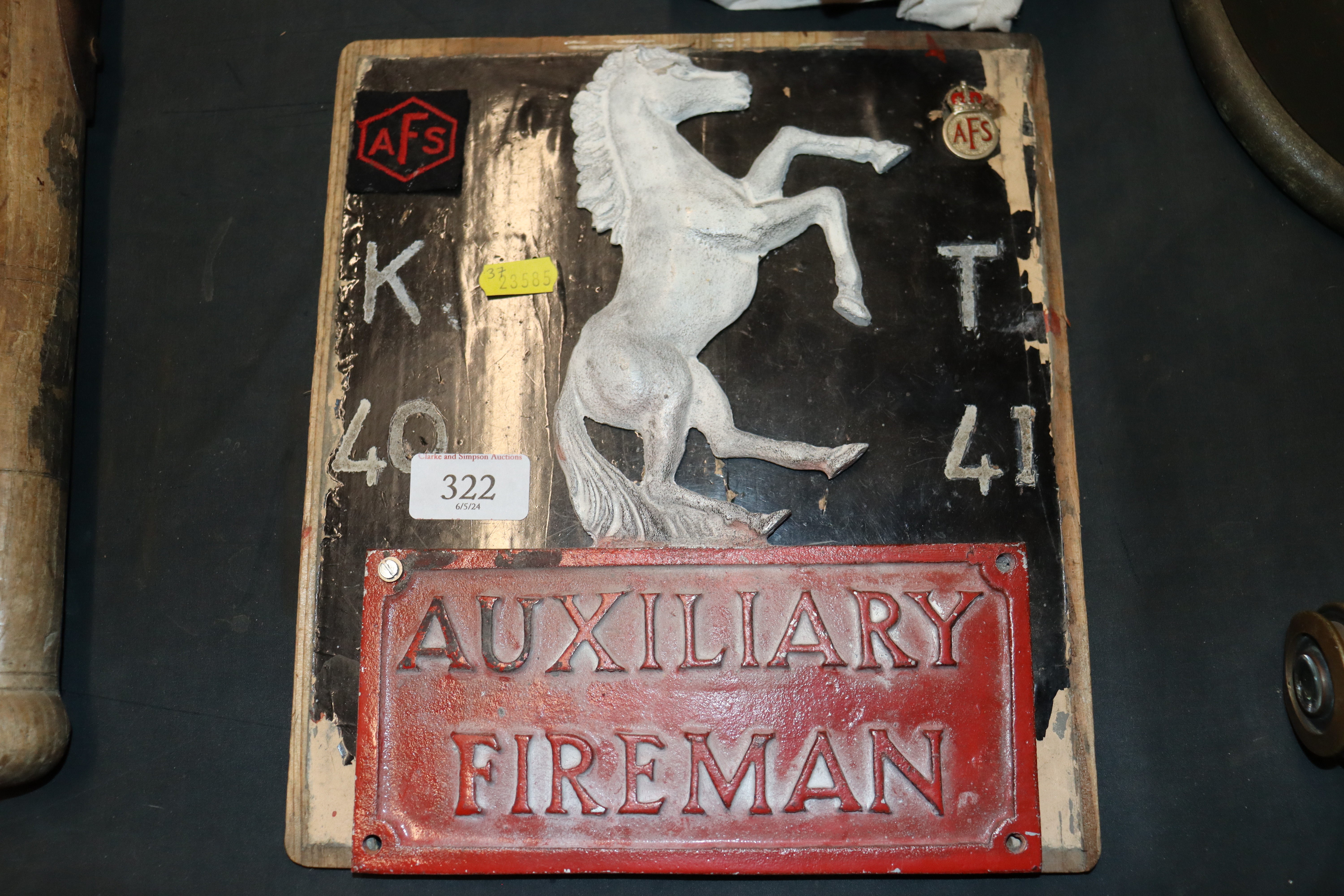 A WWII Auxiliary fireman's plaque mounted on board