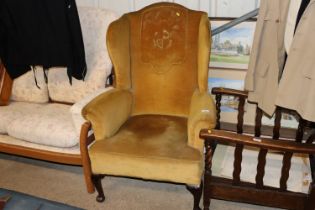 A Victorian upholstered wing back armchair