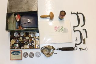 A box containing various sewing items, buttons, sc