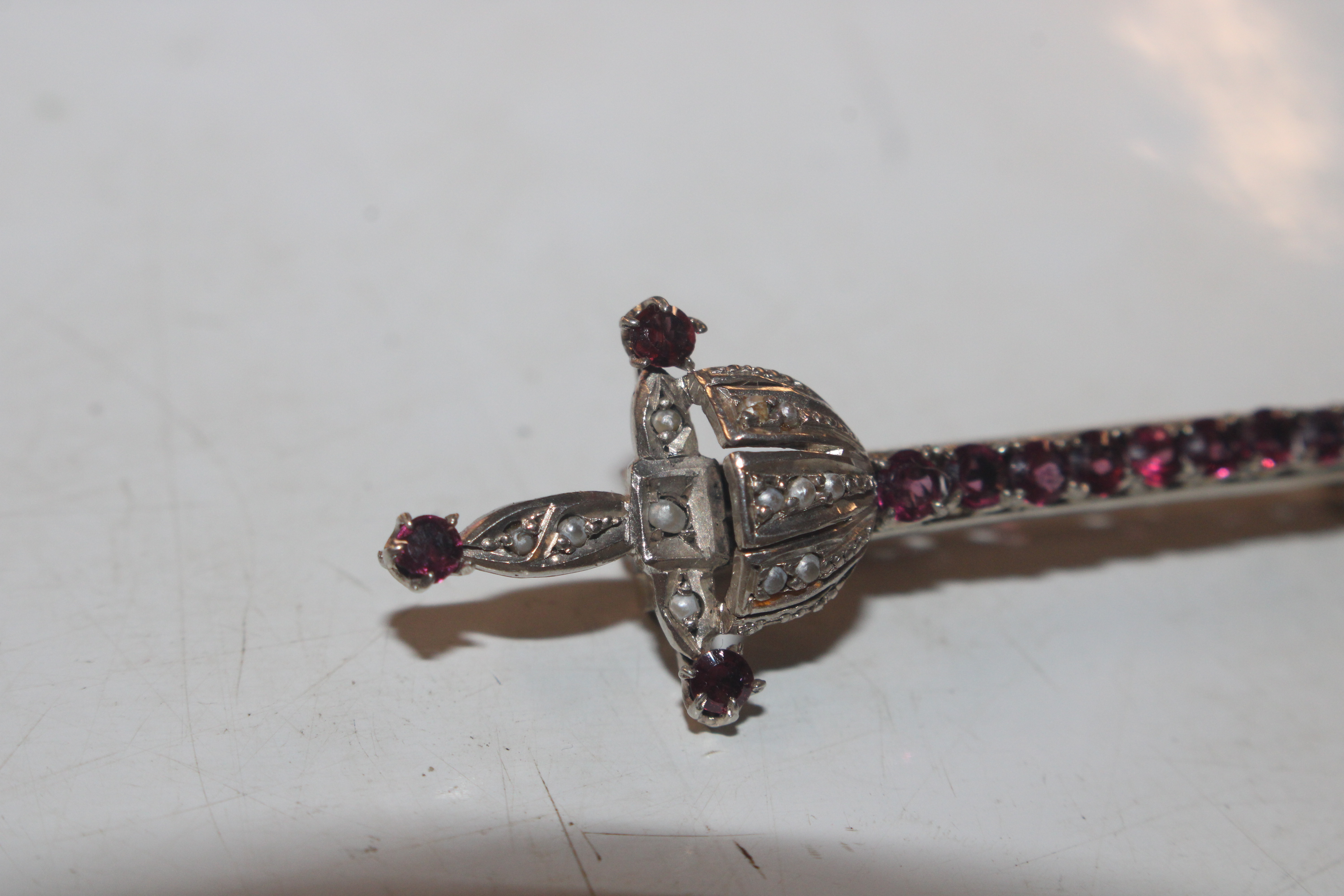 An antique 800 marked silver and garnet brooch in - Image 2 of 6