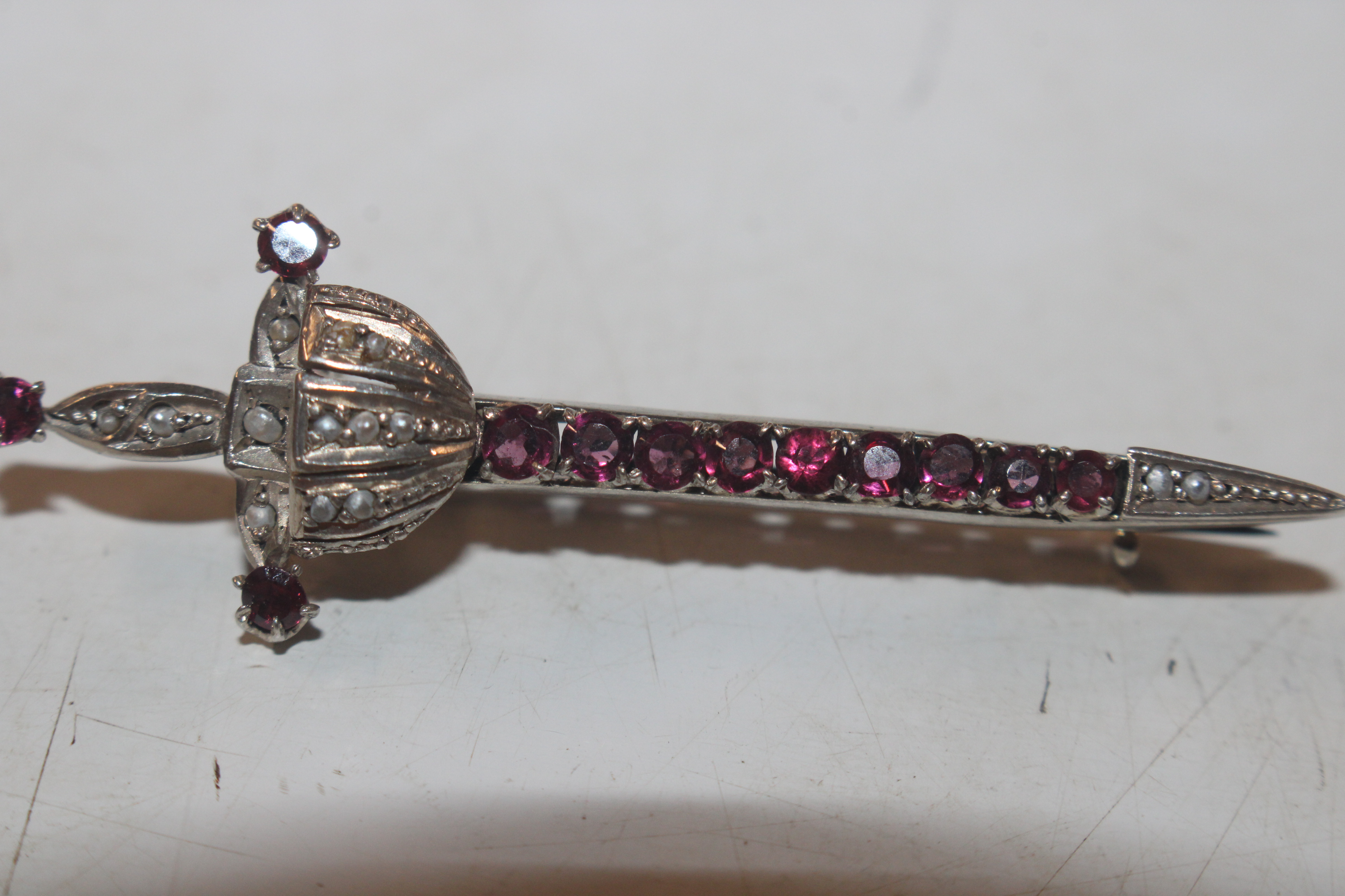 An antique 800 marked silver and garnet brooch in - Image 3 of 6