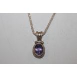 A Sterling silver and amethyst set pendant hung to