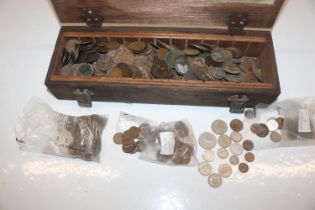 A wooden box and contents of various coinage