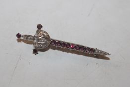 An antique 800 marked silver and garnet brooch in