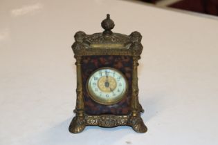 A gilt metal mounted mantel clock