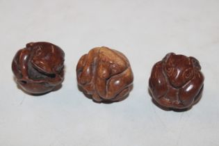 Three carved wooden Netsukes