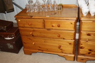 A modern pine chest fitted two short and three lon
