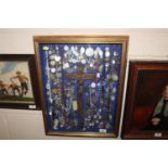 A display case of Papal medallions; rosary beads;