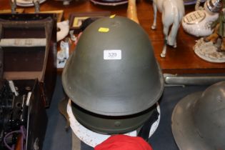 British army helmet with two other helmets