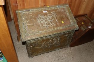 A brass embossed coal box converted to a storage b