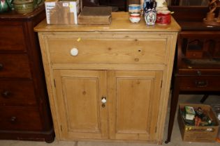 An antique pine storage cupboard fitted single dra